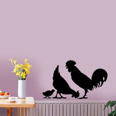 a wall decal with an image of two chickens and a rooster on it's back