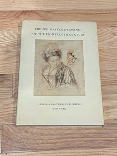 a book on french master drawings of the eighteen century sitting on a wooden table top