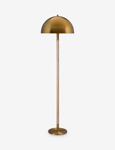 a brass colored floor lamp on a white background