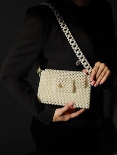 Handcrafted Beaded Pearl Bag - Elegant and Timeless Introducing our exquisite beaded pearl bag, a true embodiment of sophistication and style. Each bag is meticulously handcrafted with attention to detail, making it a unique accessory that will elevate any outfit. The timeless design of this bag makes it a versatile addition to your wardrobe. Whether you're attending a wedding, a cocktail party, or a casual brunch, this bag effortlessly complements any occasion. Compact yet spacious enough to ho Purse Wedding, Hand Beaded Bag, Pearl Clutch, Wooden Bag, Bridal Purse, Bag Elegant, Women's Bags By Style, Pearl Bag, Beaded Bag