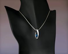 "London Blue Topaz and White Sapphire Necklace - Argentium Silver - 3418 - Argentium chain Included Make a statement with this contemporary design handcrafted by award winning designer, David Worcester. ( IMPORTANT - PLEASE READ 1. AND 2 BELOW ) 1.) INCLUDED IN THE PRICE IS AN ARGENTIUM SILVER CHAIN APPROPRIATE FOR THE PENDANT CHOSEN. YOU CAN CHOOSE FROM 16\", 18\" OR 20\" AT CHECKOUT. 2.) PLEASE LOOK AT THE MEASUREMENTS CAREFULLY. SOME PHOTOS HAVE BEEN ENLARGED TO SHOW DETAIL, WHILE OTHERS HAVE Fine Jewelry Sterling Silver Necklace With Tension Setting, Sterling Silver Fine Jewelry Necklace With Tension Setting, Sterling Silver Necklace With Tension Setting, Modern Oval Pendant Jewelry For Anniversary, Modern Silver Jewelry With Tension Setting, Modern Sapphire Jewelry With Polished Finish, Sterling Silver Wedding Necklaces With Tension Setting, Modern Sapphire Jewelry For Gifts, Wedding Necklaces In Sterling Silver With Tension Setting