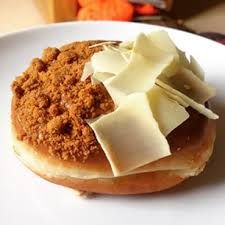 a close up of a doughnut on a plate with butter and other toppings