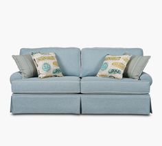 a light blue couch with two pillows on it's back and one arm facing the camera