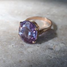 Absolutely lovely vintage created Alexandrite ring with color changing properties. Love how this ring looks deep purple to the prettiest color blue depending on the light. This piece is made with lab curundum, the same material as rubies and sapphires. Currently the ring is a size 7.75 the stone measures approx 18mm long X 15mm wide. The ring is fabricated in 10kt gold and and is very good vintage condition. Vintage Purple Promise Ring, Purple Sapphire Vintage Ring For Anniversary, Vintage Purple Sapphire Anniversary Ring, Vintage Purple Sapphire Ring For Anniversary, Vintage Purple Solitaire Ring, Vintage Purple Sapphire Gemstone Ring, Classic Handmade Purple Rings, Vintage Purple Sapphire Ring As Gift, Handmade Classic Purple Ring