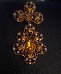 "Step into a world of timeless elegance with our Large Vintage Baroque Brooch, a piece inspired by the luxurious designs of Nina Ricci. This exquisite, unsigned treasure is more than just an accessory; it's a statement piece that encapsulates the grandeur of a bygone era. Ideal for fashion connoisseurs and collectors alike, this brooch makes for the perfect birthday gift that will be treasured for years to come. Crafted with meticulous attention to detail, this brooch features an intricate array of ornate patterns and flourishes reminiscent of the Baroque period's opulent style. The brooch is composed of high-quality materials that capture the light and dazzle the eye, ensuring that it will add a touch of sophistication to any outfit. Measuring an impressive size, it's the ideal accessory Glamour Vintage, Baroque Design, Unique Birthday Gifts, Vintage Glamour, Fashion History, True Vintage, Vintage Brooches, Icon Design, Brooches