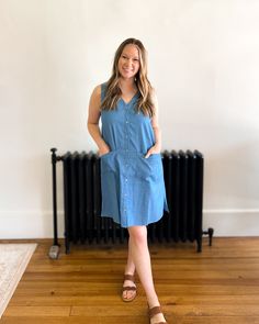 Get ready to rock the denim trend with our Denim Daze Shift Dress! This lightweight, sleeveless dress is perfect for spring and can be easily layered for a versatile look. The button up design adds a touch of functionality to this stylish piece. Embrace the denim mania with our must-have dress! Summer Chambray Button-up Shirt Dress, Everyday Summer Dresses With Buttons, Chambray Shirt Dress For Summer, Summer Chambray Shirt Dress, Knee-length Chambray Dress With Pockets, Casual Cotton Sleeveless Dress, Denim Blue Cotton Button-up Dress, Medium Wash Buttoned Midi Dress Casual Style, Button-up Denim Blue Cotton Dress