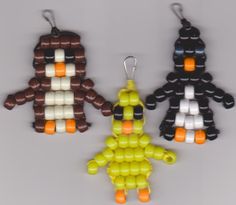 three different colored beads shaped like people