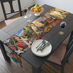 the table is set with two plates and silverware, an empty wine glass and some fruit on it