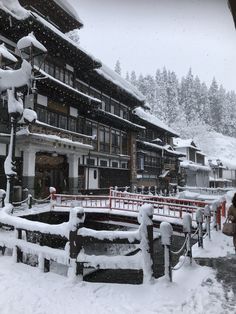 a snow covered town with buildings and trees