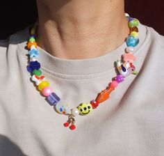 a person wearing a necklace with colorful beads