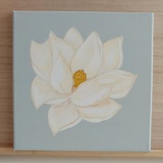 a painting of a white flower on a light blue background, with yellow stamen