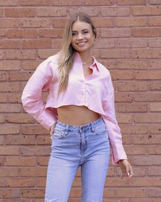 Discover the effortless charm of linen fashion with our pink button-up crop top. Crafted from premium linen fabric, this trendy piece exudes a relaxed yet stylish vibe. Perfect for sunny days and casual outings, it effortlessly combines comfort and style, making it a must-have addition to your wardrobe. Embrace the versatility and timeless appeal of this pink linen crop top and elevate your summer fashion game. | #linen #blouse #ootd Chic Long Sleeve Crop Top With Relaxed Fit, Chic Button-up Crop Top For Spring, Chic Cropped Shirt With Cropped Hem For Spring, Pink Summer Cropped Shirt, Pink Summer Crop Top Shirt, Chic Cropped Shirt For Spring, Spring Cropped Shirt For Day Out, Chic Slightly Cropped Shirt For Spring, Pink Crop Top For Summer