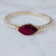 A unique engagement ruby ring in 14K solid gold with one marquise cut ruby and 10 diamonds brilliant cut. 100% handcrafted with love!PRODUCT DETAILS● Material : 14K solid gold - white gold - rose gold● Gemstones weight: Ruby 0.70ct, Diamonds 0.09ct● Gemstone shape: Marquise cut, Brilliant cut● Ruby Dimensions: 8.1mm x 4.1mmRING SIZING For General Reference:● we use standard US Ring Sizing● an average women's ring finger is size 6● if your ring size is not listed please contact usHOW TO ORDER - C Marquise Ruby Diamond Ring, Marquise Ruby Ring With Diamonds, Marquise Red Diamond Ring, Red Marquise Ruby Ring With Prong Setting, Fine Jewelry Marquise Cut Ruby Ring With Diamonds, Red Marquise Diamond Ring Fine Jewelry, Fine Jewelry Ruby Ring With Diamond And Marquise Cut, Marquise Ruby Ring Fine Jewelry, Marquise Ruby Ring For Anniversary