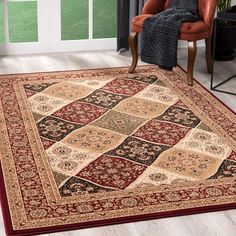 a living room with a chair and rug on the floor