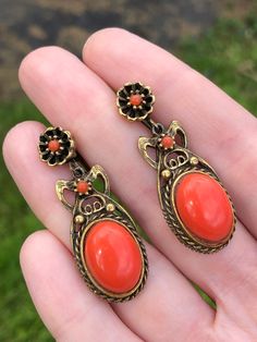 Here is a fantastic pair of vintage earrings for someone who is seeking a Victorian look. These screw backs are signed Coro and feature large cabochons that are meant to look like red coral. The ornate settings are Victorian in style. Total length is 1 3/4". Good condition with no issues that I see. Orange Victorian Jewelry For Formal Occasions, Vintage Formal Red Coral Jewelry, Elegant Red Coral Earrings, Vintage Coral Oval Jewelry, Vintage Orange Clip-on Earrings, Coral Earrings, Red Coral, Victorian Fashion, Vintage Earrings