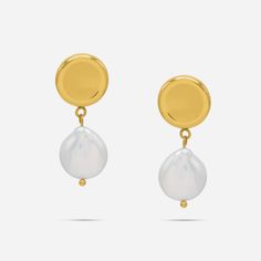 Experience a touch of elegance with our Ness Keshi Pearl Drop Earrings. Made with jewelry-grade stainless steel, these round mirrored stud earrings feature a dangling Keshi freshwater pearl. Elevate your style with these timeless and versatile earrings. Details: - Gold: 316L Stainless Steel, 18K Gold PVD Plated, Keshi Freshwater Pearls- Silver: 316L Stainless Steel, Keshi Freshwater Pearls Classic Metal Earrings With Pearl Charm, Classic Metal Pearl Earrings With Pearl Charm, Timeless Round Pearl Pendant Earrings, Minimalist Metal Pearl Drop Earrings, Timeless Round Pearl Drop Earrings, Minimalist Tarnish-resistant Round Pearl Earrings, Modern Round Pearl Earrings With Pearl Charm, Tarnish-resistant Pearl Drop Earrings, Round Metal Pearl Drop Earrings