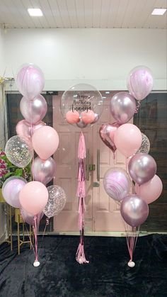 balloons and tassels are on display in front of a door