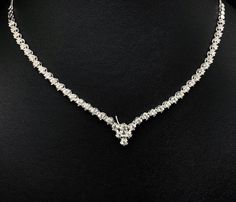 She'll never tire of wearing this classic and sophisticated diamond tennis necklace. Stunning in 18K solid white gold, this breathtaking line of shimmering round diamonds. So elegant, this 18.0-inch diamond necklace will take her breath away. Radiant with 3.08 cts. t.w. of diamonds and buffed to a brilliant luster, this glamorous keepsake secures with a box clasp. The setting design make the diamonds look much bigger than they are. When worn, the diamonds look like 1/5 carat each. Diamonds Detai Timeless Diamond Cut Tennis Necklace For Wedding, Wedding Tennis Necklace In White Gold Platinum, Classic Diamond Tennis Necklace For Wedding, White Gold Platinum Tennis Necklace For Wedding, Classic Formal Necklaces With Tension Setting, Classic Platinum Tennis Necklace For Anniversary, Platinum Tennis Necklace For Weddings, Formal Diamond Necklace With Tension Setting And Round Cut, Formal White Gold Diamond Necklace With Tension Setting