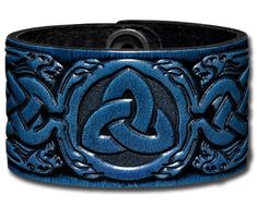 Width: 40mm (1.6inch) Thickness: approx 2,5-3mm (6-7oz) Material: veg-tanned full grain leather (cowhide) Color: blue-antique Design: Trinity with Celtic Dragon Heads (4) / Embossed Fastening: 2 Snap Fasteners, Material: brass (nickel free), Finish: nickel-antique, Design: Triskel Sizes: M to 4XL Embossed and antique dyed strong leather bracelet made of vegetable tanned full grain leather with two snap fasteners. The bracelet has a width of 40mm (1.6inch) and a thickness of approximate 2,5-3mm ( Adjustable Blue Engraved Cuff Bracelet, Adjustable Nickel-free Blue Cuff Bracelet, Art Du Cuir, Dragon Heads, Celtic Dragon, Hand Painted Jewelry, Leather Art, Dragon Head, Leather Cuffs Bracelet