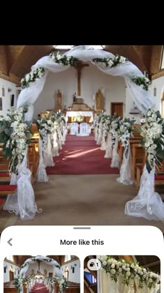 the wedding arch is decorated with white flowers and greenery