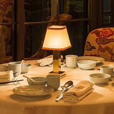 the table is set with dishes, cups and saucers for two people to eat