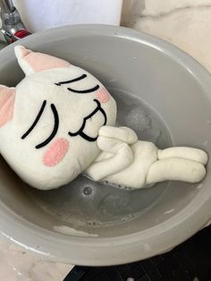 a stuffed cat in a bathtub with water