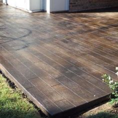 a wooden deck in front of a house