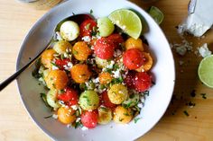 a white bowl filled with lots of different types of food