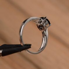 It is a natural black spinel ring. The main stone is 7mm*7mm round cut, weight about 1.65 carats. The basic metal is sterling silver and plated with rhodium. To change the metal to a solid gold (white/rose) or platinum is also available, please ask for a quotation if you want. You can also go to my shop Home for more elegant rings: https://www.etsy.com/shop/godjewelry?ref=hdr_shop_menu More black spinel rings: https://www.etsy.com/shop/godjewelry?ref=seller-platform-mcnav&section_id=21680005 14k White Gold Solitaire Jewelry, White Gold Round Jewelry With Polished Finish, White Gold Jewelry With Polished Finish, Polished White Gold Jewelry, Modern Jewelry With Prong Setting And Round Cut, 14k White Gold Jewelry With Prong Setting, 14k White Gold Open Ring With Brilliant Cut, Fine Jewelry In 14k White Gold With Prong Setting, 14k White Gold Round Stone Jewelry