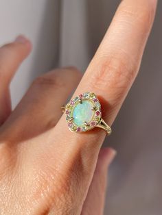 Cosmic Pastel Opal Solitaire Ring – Margaux Perrier Jewelry Multicolor Oval Jewelry With Halo Setting, Multicolor Oval Halo Setting Jewelry, Oval Multicolor Jewelry With Halo Setting, Multicolor Halo Rings Fine Jewelry, Multicolor Jewelry With Halo Setting For Wedding, Multicolor Halo Setting Jewelry For Wedding, Multicolor Halo Setting Wedding Jewelry, Cluster Halo Ring As A Gift, Celestial Oval Multi-stone Ring