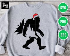 the silhouette of a bigfoot wearing a santa hat is shown on a gray sweatshirt