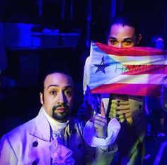 man and woman holding up a flag in front of them