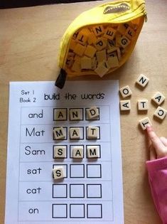 a banana sitting on top of a table next to scrabble letters