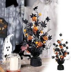 two halloween decorations on a table next to a candle holder with pumpkins and flowers