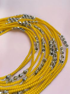 This meticulously handcrafted waist bead is designed to illuminate your silhouette with the cheerful glow of sunshine. Immerse yourself in the inviting warmth and lively charm of this waist bead, created to bring a touch of positivity and vibrancy to your style. ☀️ Yellow Glass Seed Beads - Radiant Joy: This waist bead is adorned with yellow glass seed beads, symbolizing radiant joy and positivity. Yellow is a color associated with energy and happiness, bringing a sunlit warmth to the waist bead Waist Beads, Free Tshirt, Belly Chain, Craft Accessories, Anklet Bracelet, Glass Seed Beads, Bead Crafts, Anklets, Seed Beads