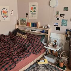 an unmade bed sitting in a bedroom next to a desk and bookshelf