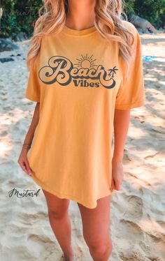 Experience the incredible softness and quality of our Comfort Color shirts, perfect for those sun worshipers and ocean lovers who crave the feeling of sun-kissed skin and sandy toes. Whether you're a surfer catching the perfect wave, a beachcomber seeking unique treasures, or simply enjoying the soothing sounds of the ocean waves, our shirts are designed for you. With designs featuring palm trees, surfboards, and beach bonfires, you'll find the perfect tee to showcase your passion for the beach Yellow T-shirt For Spring Vacation, Casual Yellow T-shirt For Vacation, Vsco Style Graphic Print T-shirt For Vacation, Casual Beach T-shirt For Warm Weather, Summer Short Sleeve T-shirt For Warm Weather, Casual Crew Neck T-shirt For Vacation, Summer Vacation Shirt For Beach Season, Summer Beach Vacation Shirt, Summer Beach Season Vacation Shirt