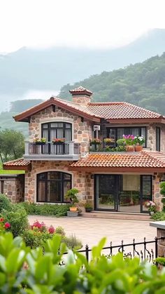 a large stone house with lots of windows and balconies on the top floor