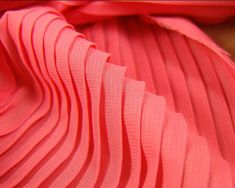 the pleaed fabric is bright pink and has very thin folds on it's sides