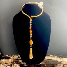 This Unique Artistically Designed Gold Tone Metal Classic Hinged Chocker Necklace Is 6” In Diameter. The 10” Single Line Drop Is Designed With Clear Chrystal Beads, Gold Tone Metal Small Beads And Couple Amber Color Natural Stones. The Shiny Yellowish/ Beige Color Of The Beads On The Tassel Matches So Perfectly To The Colors Of The Natural Stones. Clear Necklace, Necklace With Beads, Pebble Necklace, Turquoise Charm, Flower Statement Necklace, Rhinestone Statement Necklace, Amethyst Necklace Pendant, Square Necklace, Chocker Necklace