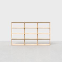 an empty wooden shelf against a white background