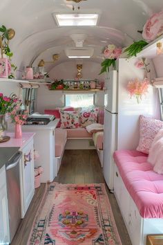 the interior of an rv decorated in pink and white with lots of flowers on the ceiling