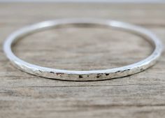 This sterling silver bangle comes in either a smooth or a finely hammered finish. It is a simple, minimalist, elegant bracelet, perfect stacked with other bangles, or worn on its own. ⚙️ DETAILS ~ Approximately 2.7 mm square, medium size is approximately 14 g ~ Smooth or finely hammered ~ Polished finish ~ Message me if you would like to discuss a different finish (eg satin, oxidised/blackened)) Available in four sizes (diameter in brackets) ~ small (60 mm)  ~ medium (64 mm)  ~ large (67 mm)  ~ Hammered Bracelet, Bracelet Simple, Jewelry Aesthetic, The Bangles, Sterling Silver Bangle, Hammered Sterling Silver, Elegant Bracelet, Silver Bangle, Sterling Silver Bangles