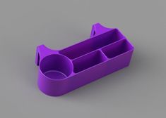 a purple plastic cup holder on a gray surface with two compartments for pens and pencils