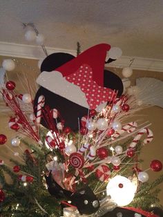 a christmas tree decorated with candy canes, candies and santa's hat