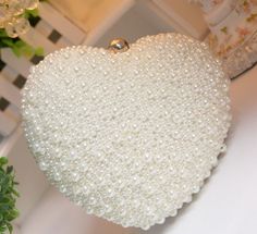 This beautiful ARIA Clutch is a perfect accessory for any formal occasion. Crafted from pearls with delicate details, it will add elegance and sophistication to any ensemble. With a secure closure, this clutch ensures your essentials stay safe and secure. Detachable Chain Included Pearl Clutch Bag, Heart Clutch, Pearl Party, Pearl Clutch, Wedding Handbag, Bridal Handbags, White Clutch, Beaded Evening Bags, Wedding Purse