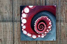 an abstract painting on wood with red and white circles in the center, surrounded by pearls