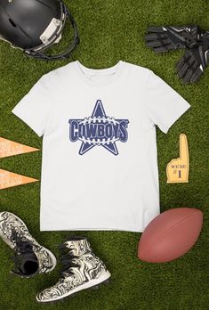 Looking for the perfect Cowboys Football T-shirt to show off your team spirit? Look no further! Our shirts are available in both black and white, making it easy to match your game day outfit. But what sets our shirts apart is the ability to customize the design. If you have any requests or ideas for changes, please reach out to us through the message box before placing your order. We want to ensure that you receive exactly what you're looking for. And if you're in search of a truly unique gift, we can also create a custom design just for you. From personalized gifts for Mom and Dad, to gifts for your boyfriend or husband on their birthday, we've got you covered. Our shirts also make great gifts for boys and football fans of all ages. Our shirts are perfect for vintage football enthusiasts, Football Season Fan Gear T-shirt, School Spirit T-shirt For Tailgating With Crew Neck, School Spirit Crew Neck T-shirt For Tailgating, School Spirit T-shirt For Tailgating, Pre-shrunk T-shirt For Game Day And Sports Season, White T-shirt With Team Logo For Football Season, Sports Fan Short Sleeve Top For Tailgating, White T-shirt With Football Team Logo, Short Sleeve Sports Fan Tops For Tailgating