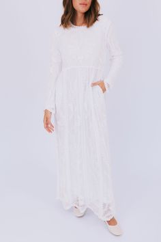 Adorned throughout with a beautiful lace embroidered overlay, The White: Clara Dress is stunning. Thoughtfully designed with pockets, a high neck, and long sleeves, the Clara Dress is modest in the best way. You will feel beautiful at any event. Details Lace embroidered overlay Fully lined Rounded high neck Lace details Pockets! Slightly relaxed fit Long sleeves LDS temple dress Sizing Approximate measurements: SIZE LENGTH BUST S/M 57" 38" M/L 57.5" 42" XL 58" 46" Fits true to size Fabric has no stretch Model is 5’8” wearing s/m Material 60% Cotton 40% NylonLining: 100% PolyesterHand wash coldDo not bleachHang or line dry Lds Temple Dress, Temple Dress, Lds Temple, Lds Temples, Event Details, Feel Beautiful, Neck Lace, How To Feel Beautiful, Lace Detail