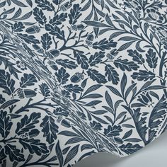 a blue and white wallpaper with leaves and flowers on it's back side